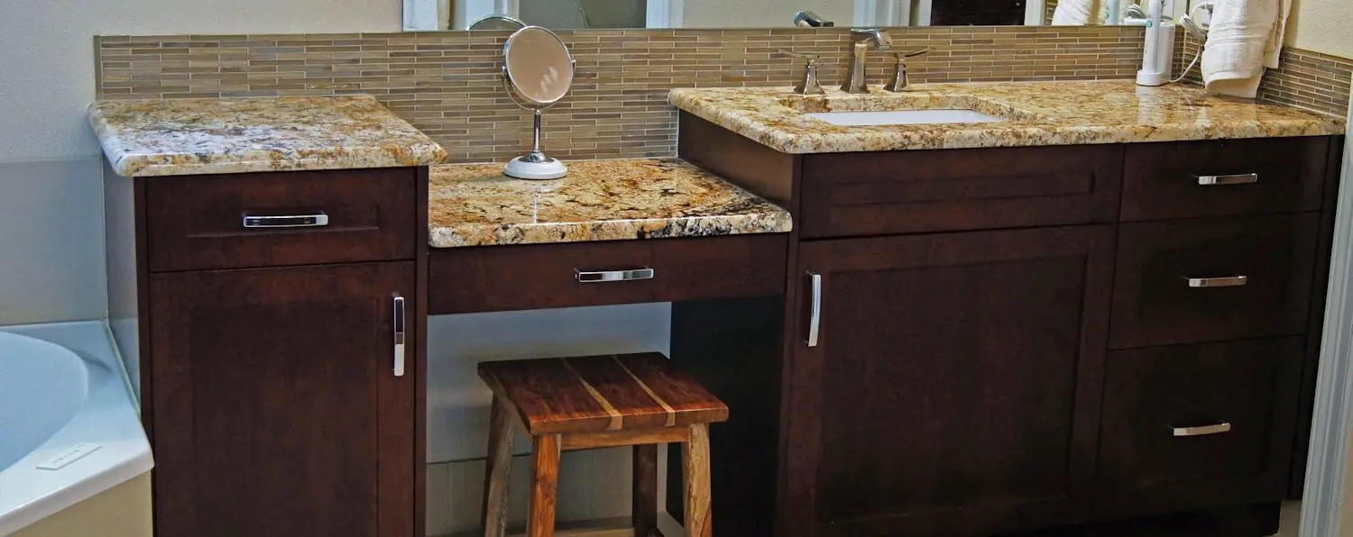 A bathroom with two sinks and a mirror.