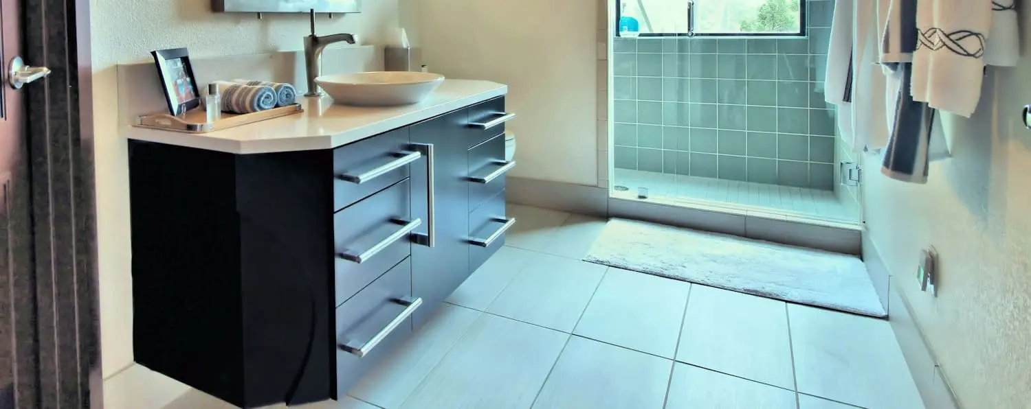 A bathroom with a sink and shower in it