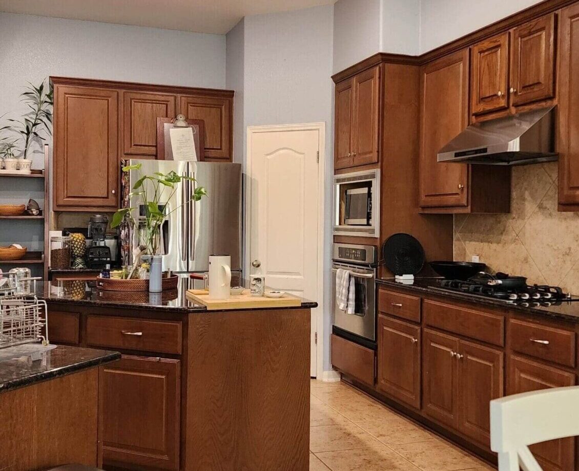 A before kitchen photo showing the old style cabinetry